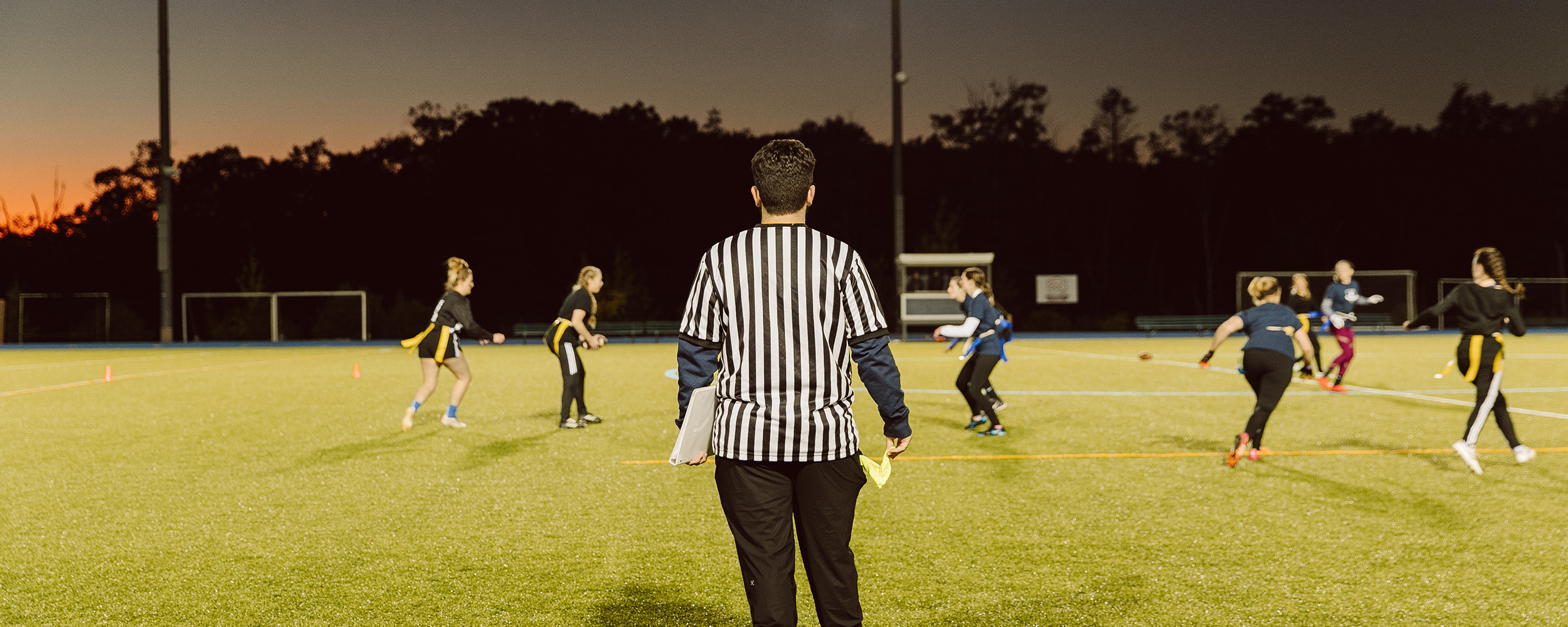 photo taken behind the referee while a group of female students at our Christian college play flag football