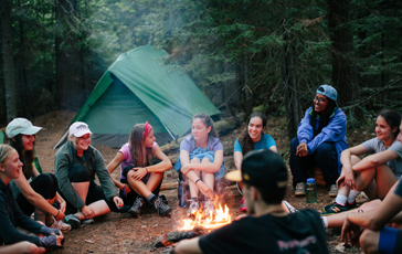 First-year Gordon College students sitting around a campfire during one of their La Vida Expeditions.
