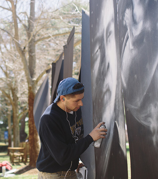 David Popa working on graffiti installation