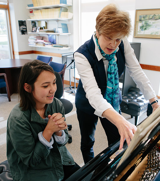 Student being instructed on the piano