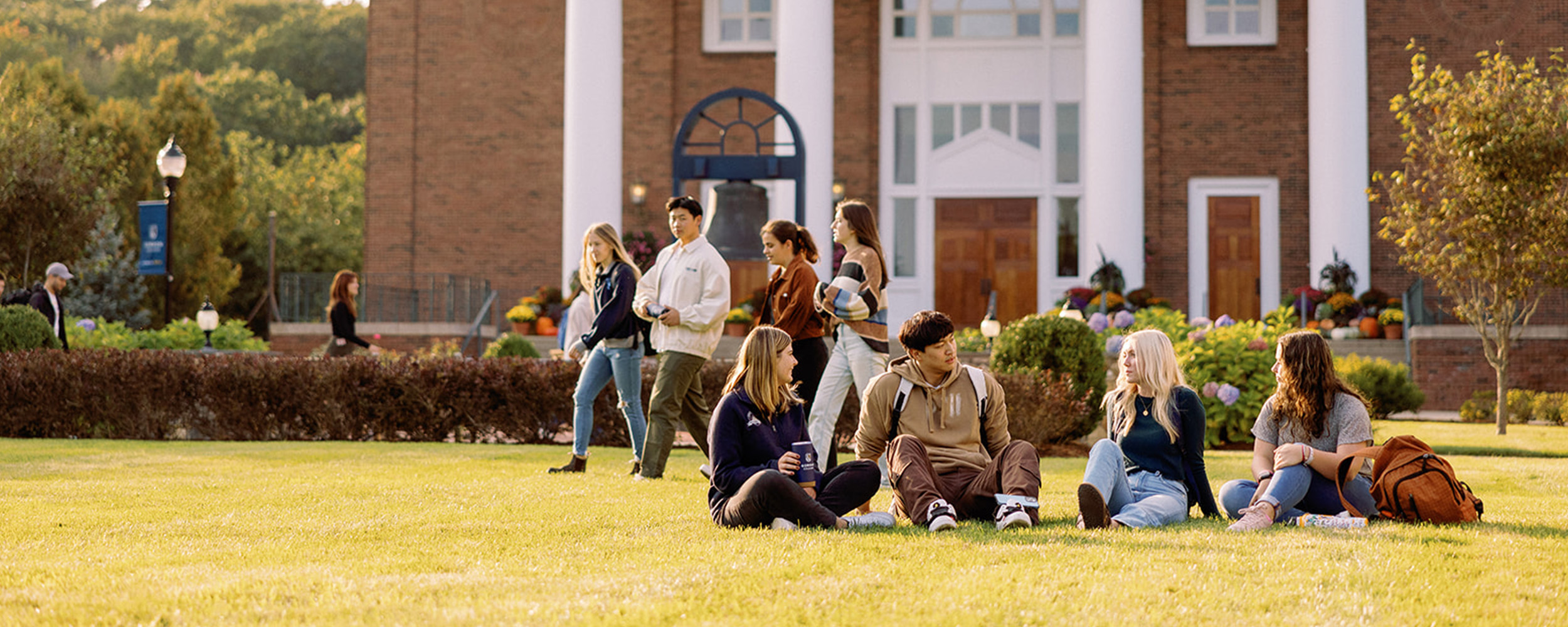 students talking on the grass