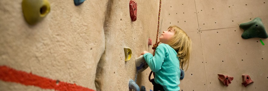 Child climbing in rock gym