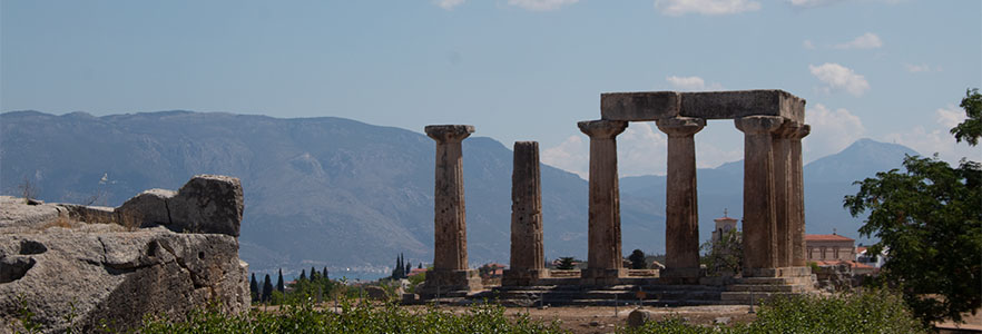 Ancient Greek ruins with mountains in the background