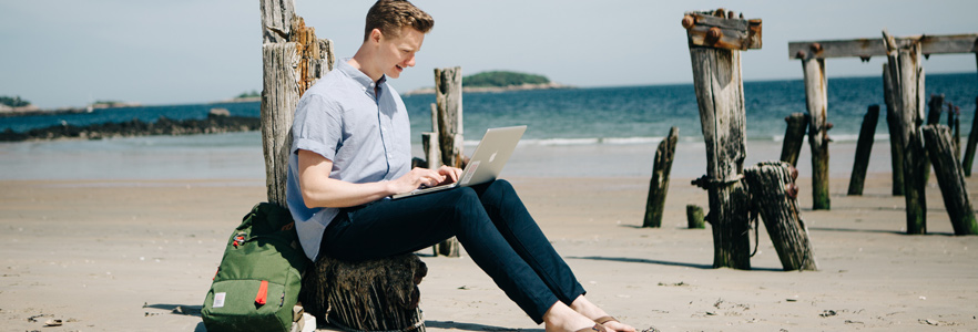 Student studying on the beach