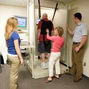 Marie Lucey demonstrating the Balance Master to Kinesiology students