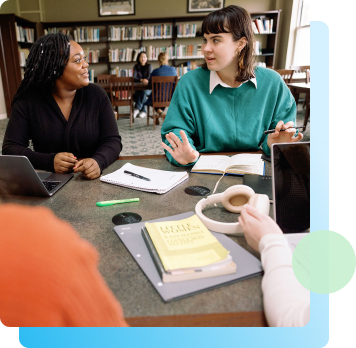 photo of student talking together in the library.